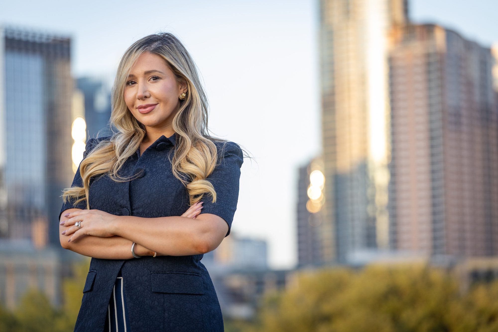 Laura Davis, co-founder of USLege and keynote speaker on AI for government affairs, standing against the Austin, Texas skyline.